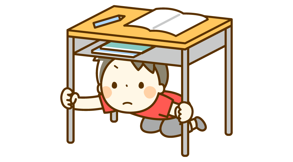地震の時に机の下に隠れる男の子